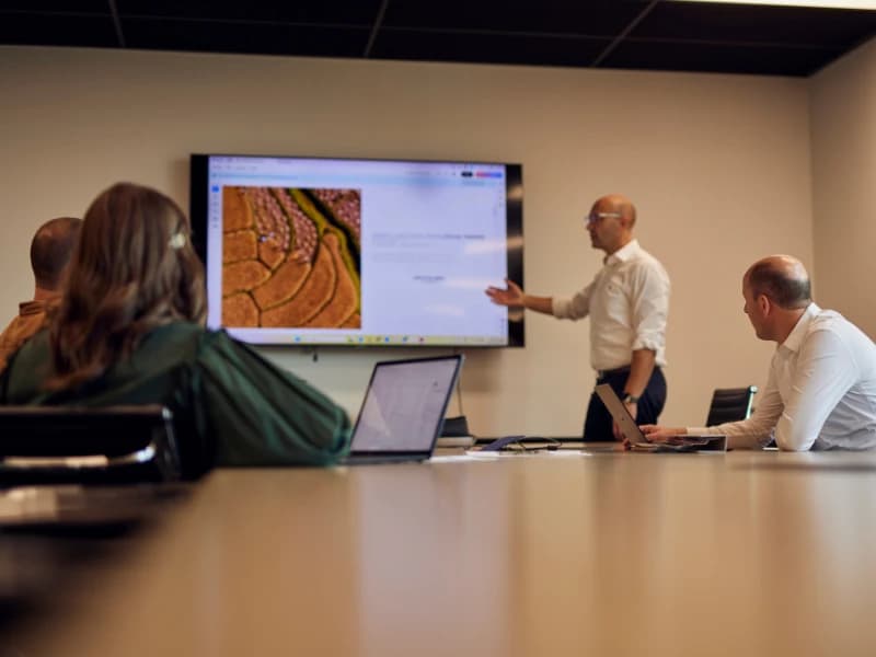 Astro Hospitality team members presenting to colleagues in a meeting room